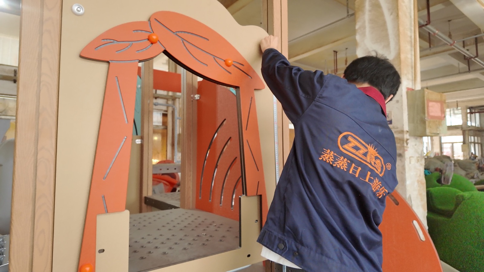 ZZRS technician checking a playground equipment trial assembly at the factory